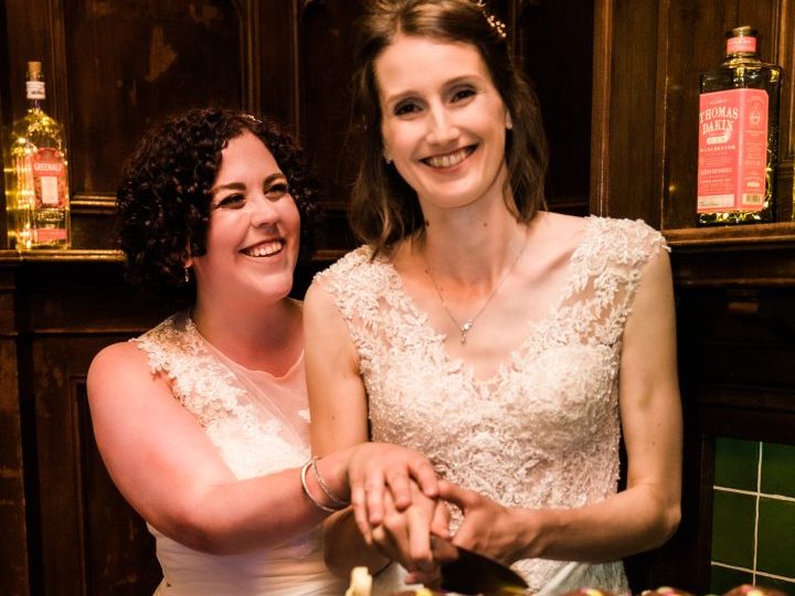 Maddy and Emma cutting the wedding cake